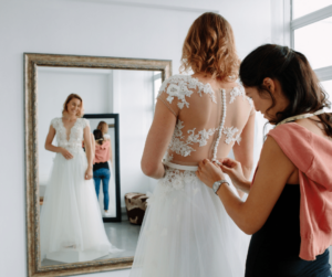 Image of woman trying on wedding dress